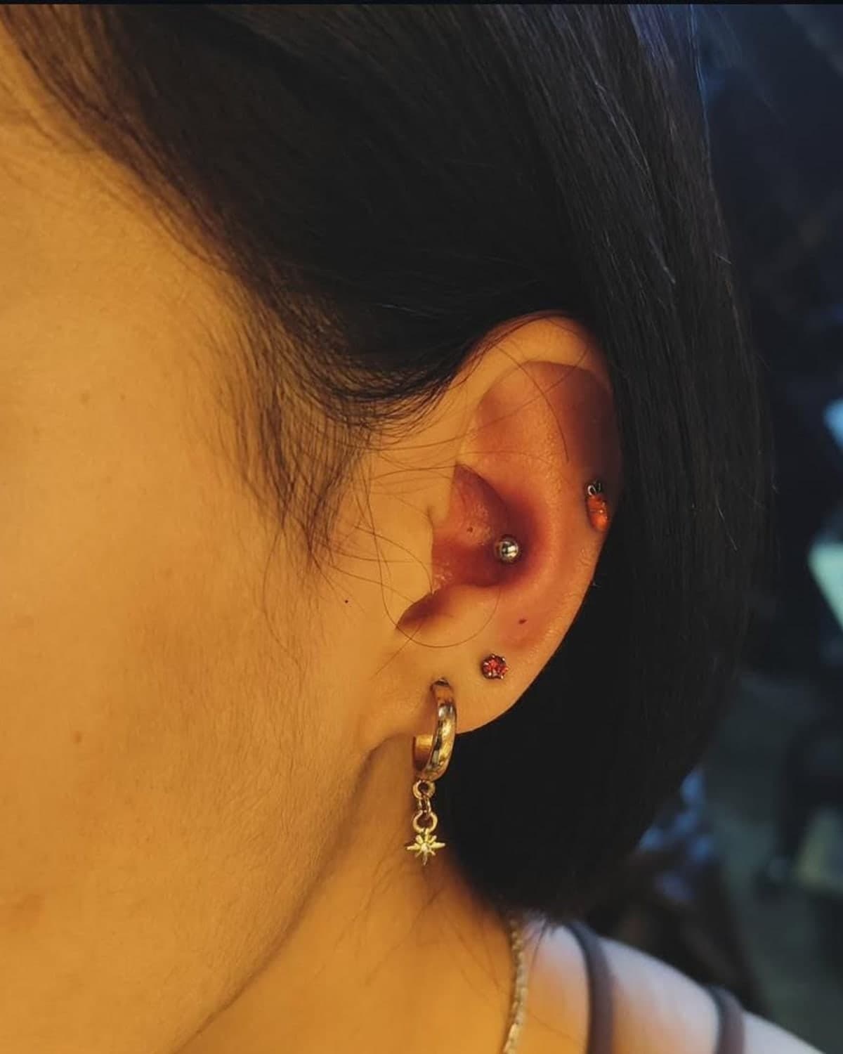 Multiple ear piercings with gold and gemstone jewellery